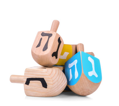 Wooden dreidels for Hanukkah on white background