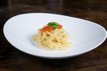 italian spaghetti with tomato and basil in a pot