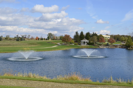 Beautiful Wedding Gazebo in the park with fountains in the pond on a sunny summer day - Powered by Adobe