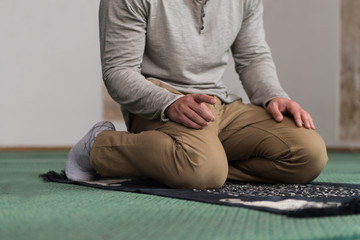 Close-Up Of Male Hands Praying In Mosque