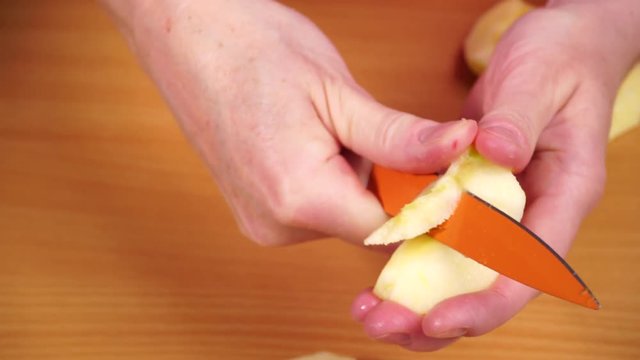 Woman housewife in kitchen at home cutting apple removing seeds. Healthy eating, cooking, raw food, dieting and people concept. 4K ProRes HQ codec