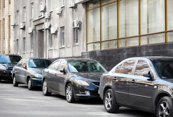 Fototapeta na wymiar Cars parking near building