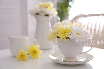 Flower bouquet of chrysanthemum in cup on table