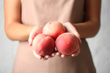 Woman holding fresh peaches