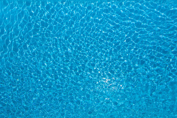 Fototapeta na wymiar Beautiful blue water surface in swimming pool