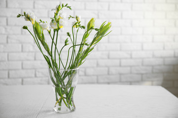 Plants composition in glass vase on table in the room