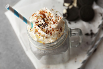 Delicious milk dessert in glass jug on table, closeup