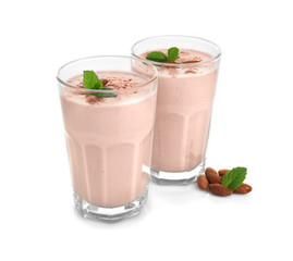 Glasses with delicious nut milk shake isolated on white