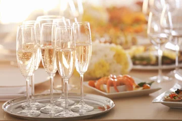 Fotobehang Tray with glasses of champagne on wooden table, close up view © Africa Studio