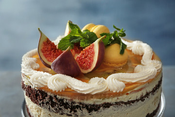 Delicious creamy cake with figs on light grey background