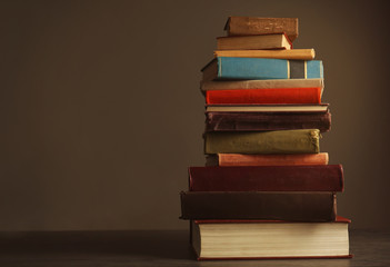 Pile of books on table and dark background
