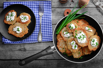 Composition with tasty potato pancakes for Hanukkah on wooden table