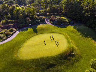 Aerial Photo of Men on a Golf Course Putting Green
