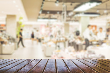 Brown wooden planks over blurred superstore background