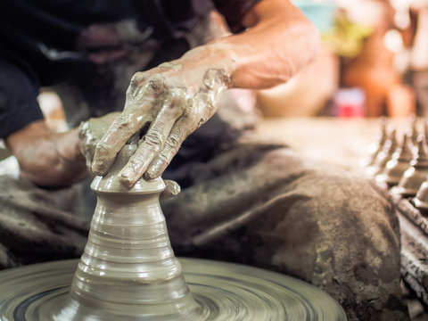 Hands of a potter, making pottery on pottery wheel (potter, handmade, clay)