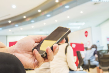 A man is using telephone over colorful blurred bokeh light in of