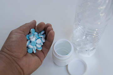 .Water bottles, medicine bottles, pills, put on a white backgrou