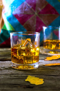 glass of whiskey with ice on background Scottish ornament