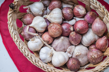 Fresh shallots and garlics in the basket