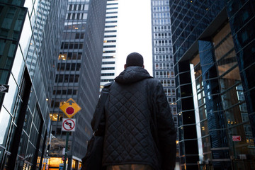 Back view of young African American professional in the city