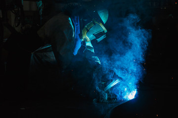 Obraz na płótnie Canvas Welder of Metal Welding with sparks in industry steel weld