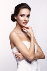 Portrait of beautiful young brunette woman bride in white Wedding dress