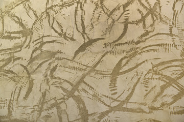 Muro intonacato graffiato.