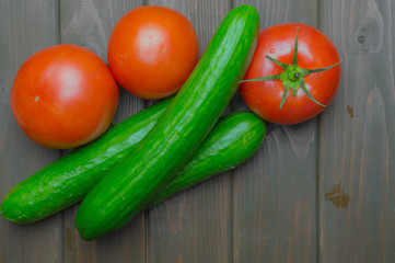 Fresh vegetables and fruits top view on dark wooden background.