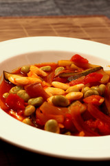 Vegetarian mixed bean casserole in a white bowl