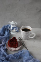 Cup of hot coffee and red velvet cake on rustic stone background. Valentine's day celebration concept. place for text