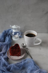 Cup of hot coffee and red velvet cake on rustic stone background. Valentine's day celebration concept. place for text