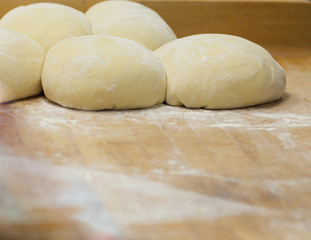 Fototapeta na wymiar Freshly Made Dough Resting On A wooden Surface