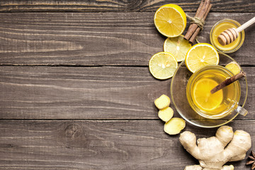 Fototapeta na wymiar transparent cup of green natural tea with ginger, lemon, spices