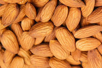 Almonds background. Pile of selected almonds close-up. For vegetarians.