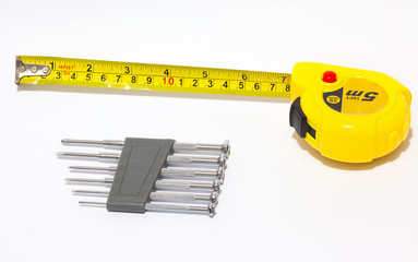 Set of screwdrivers and tape measure.