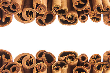 Fototapeta premium Cinnamon sticks closeup on white background. Isolated. Decorative border of cinnamon sticks spice.