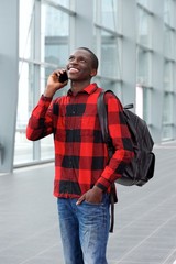Fototapeta premium Happy young african man talking on mobile phone