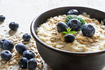 oatmeal porridge with ripe blueberries. close up - obrazy, fototapety, plakaty