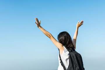 pretty asian girl relax with blue sky, freedom and travel concep