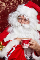 Portrait of Cheerful Santa Claus in Christmas concept  against r
