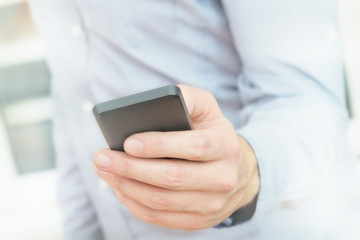 Urban guy / businessman with a cellphone. Shallow depth of field.