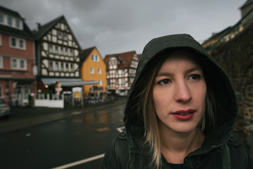 Close up woman portrait in small town, rainy day