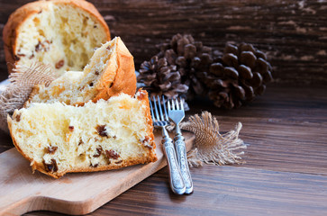Panettone, Traditional Italian Christmas cake  on rustic background with vintage fork. Copy space.