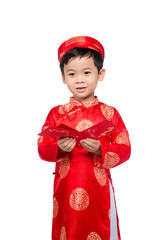 Little Vietnamese boy holding red envelops for Tet. The word mea