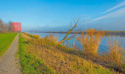 Shore of a canal through the countryside at fall