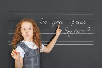 Surprised redhead girl asks a question -  Do you speak English