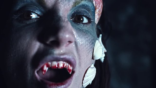 4k Halloween Shot of a Horror Woman Mermaid Showing Bloody Vampire Teeth