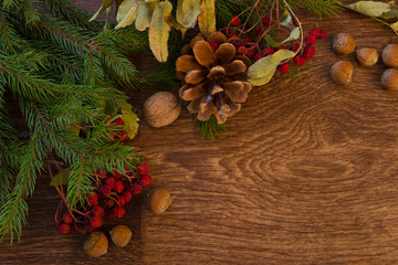 Obraz na płótnie Canvas Christmas decorations garland Christmas tree branch on wood