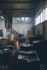 Metallurgy heavy industry. Factory hall for production of heavy pellet stoves and boilers.  Extremely dark conditions and visible noise.