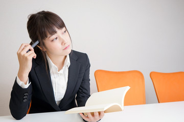 Young woman thinking something at office